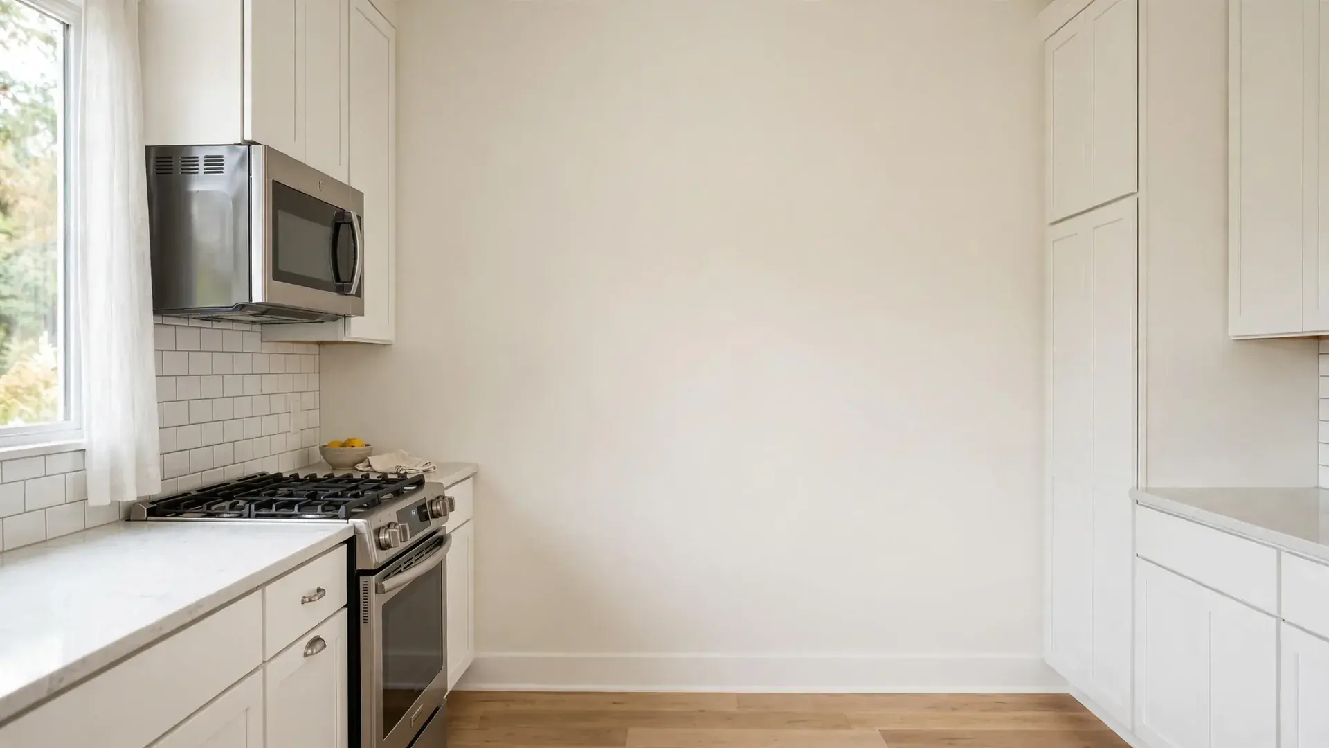 Over the range microwave above a gas cooktop in a bright kitchen